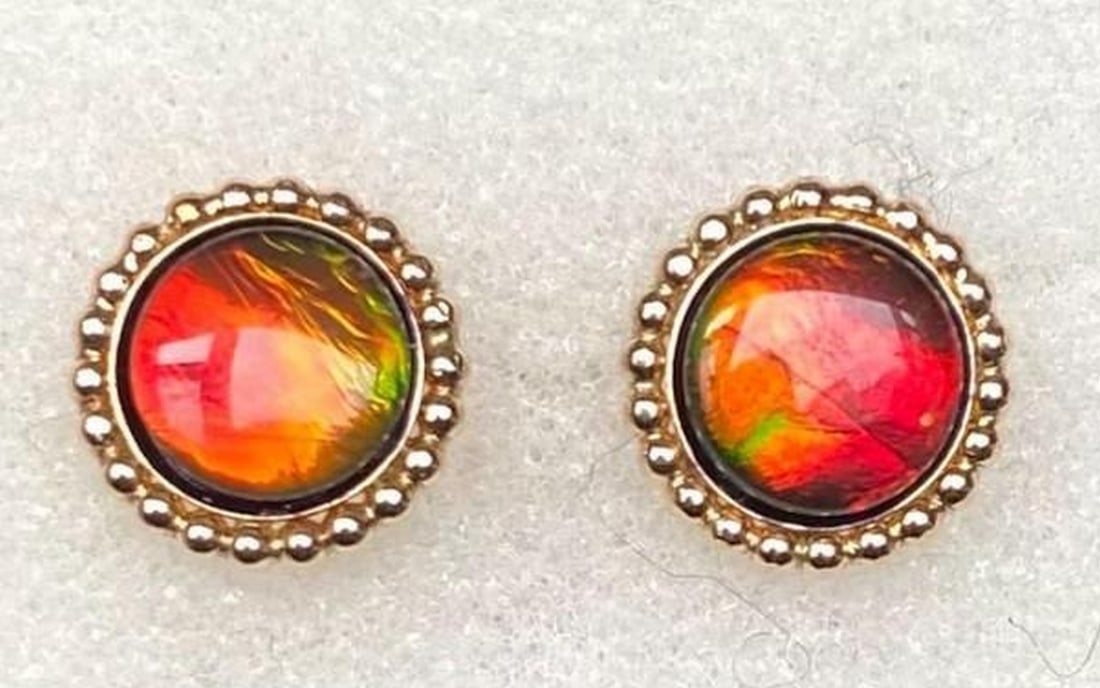 Solar Flare Ammolite Stud Earrings: Solar Flare Ammolite Stud Earrings These ammolite stud earrings capture the mesmerizing beauty of this rare gemstone, shimmering with dynamic hues that shift in the light. Each stone, formed from foss