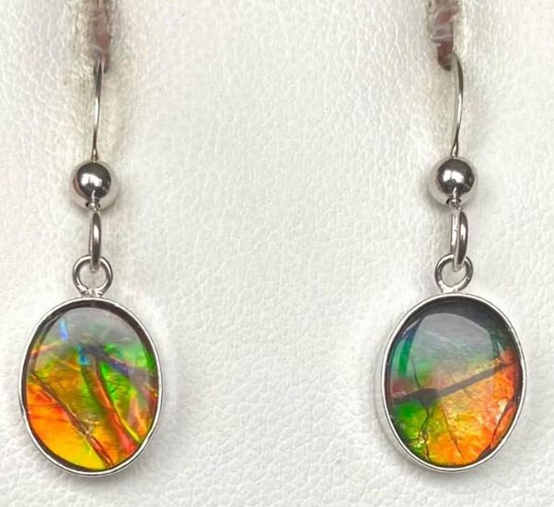 Ember Tide Ammolite Earrings: Ember Tide Ammolite Earrings The Ember Tide Ammolite Earrings glow with captivation of fiery orange and deep teal, evoking the meeting of flame and ocean. Their luminous, shifting hues catch the light