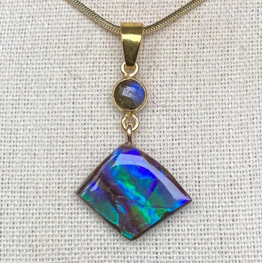 Blue & Green Ammolite Pendant with Labradorite Accent: Blue &; Green Ammolite Pendant with Labradorite Accent This ammolite pendant features blue and green tones, with the green being more prominent than the photos reveal. The gem has a thin coating and