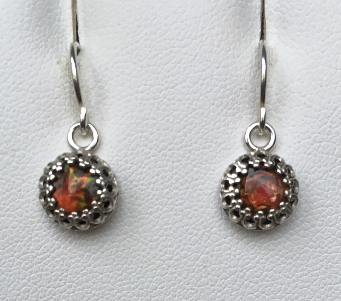 Deep Red Ammolite & Sterling Silver Earrings: Deep Red Ammolite &; Sterling Silver Earrings These earrings feature 7mm round gemstones set in sterling silver gallery wire with a subtle oxidized finish. Suspended from elegant French hooks, they