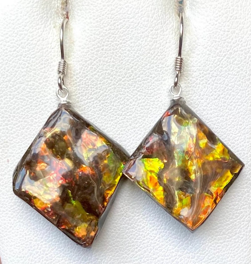 Autumn Coloured Square Ammolite Earrings: Autumn Coloured Square Ammolite Earrings This pair of earthy Ammolite earrings features gemstones averaging 25mm x 21mm with a thin coating. One stone is slightly larger, though it's unlikely to be