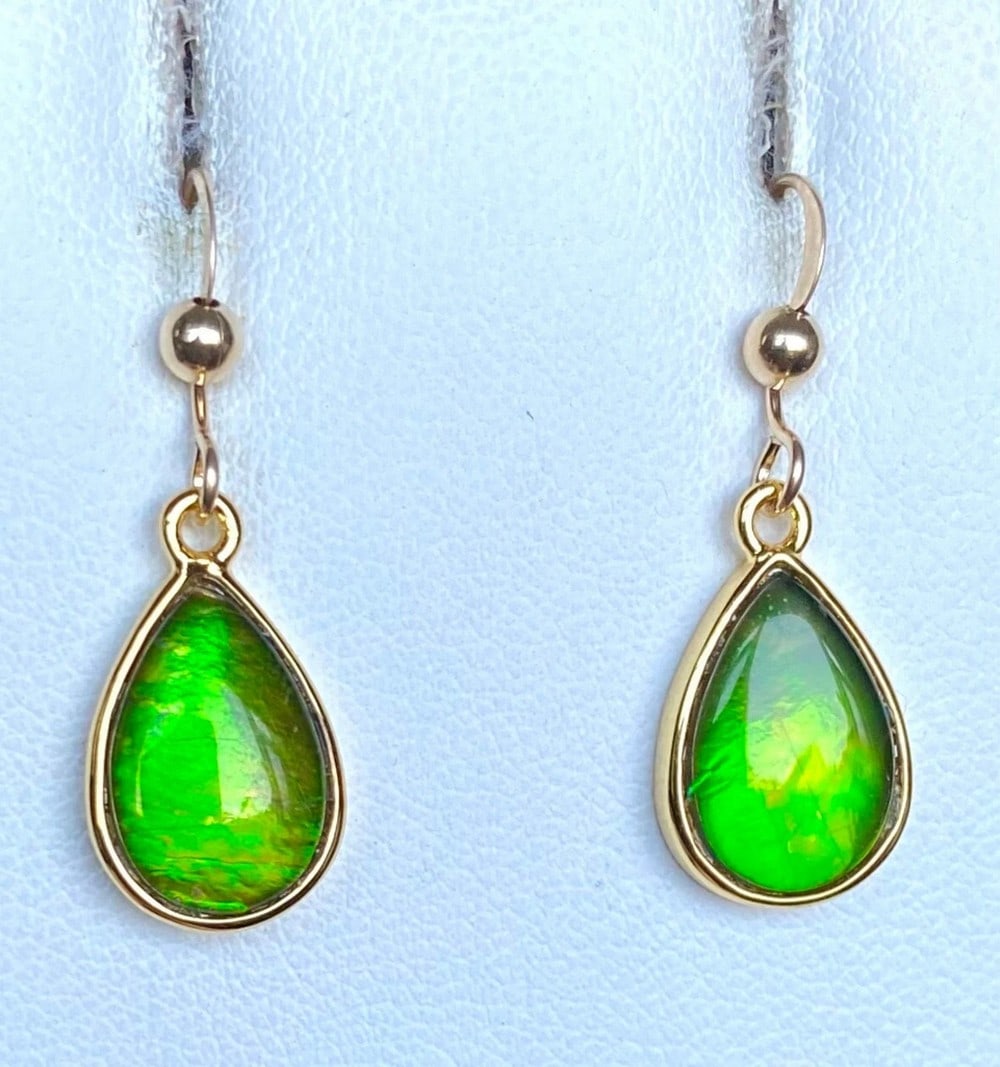 Teardrop Green Ammolite Earrings: Teardrop Green Ammolite Earrings These teardrop-shaped Ammolite earrings feature 12mm x 8mm low-dome quartz-capped triplets. Set in gold-plated (vermeil) sterling silver, they are paired with durable
