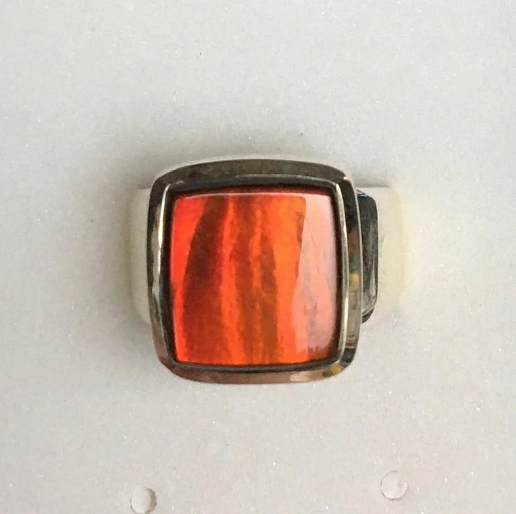Elemental Light Ammolite Ring - Size 8: Elemental Light Ammolite Ring - Size 8 This stunning ring features a vibrant red ammolite gemstone, measuring 11mm x 11.5mm in a freeform shape. At extreme angles, the stone shifts to a beautiful