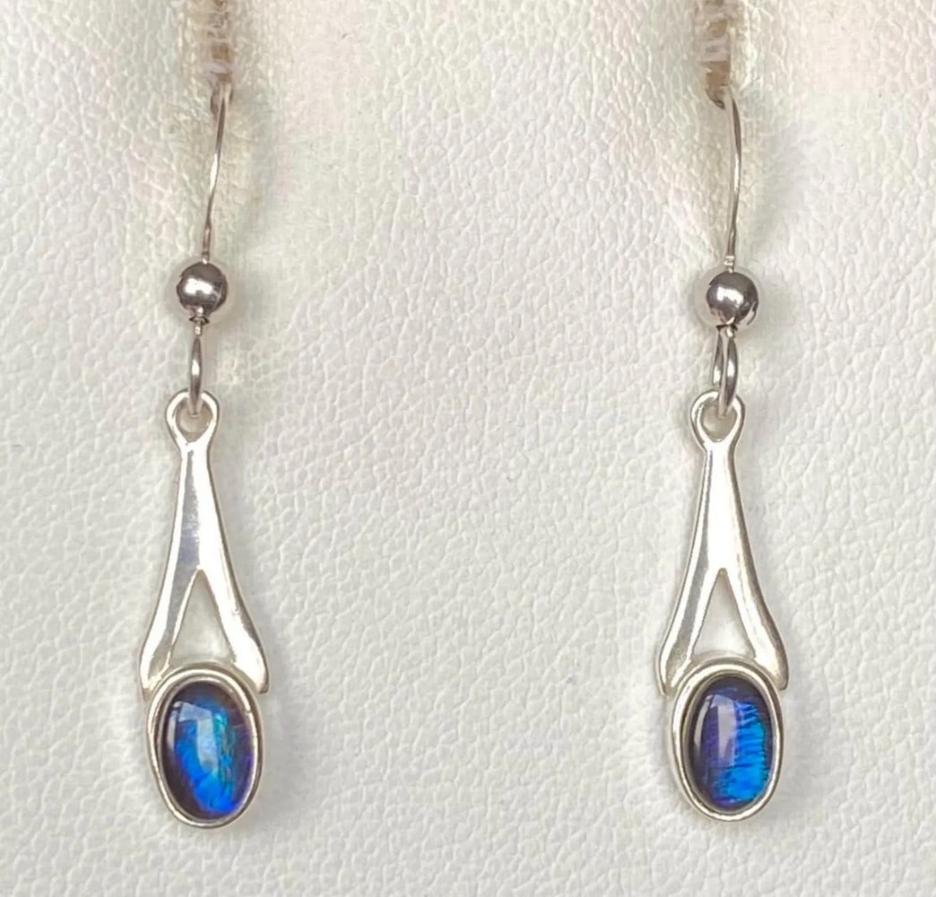 Petite Blue Ammolite Earrings: Petite Blue Ammolite Earrings This is a set of Ammolite earrings with petite blue gems. Although the blue is pretty good, they are not quite as bright as the photos. Blue is very difficult to capture 