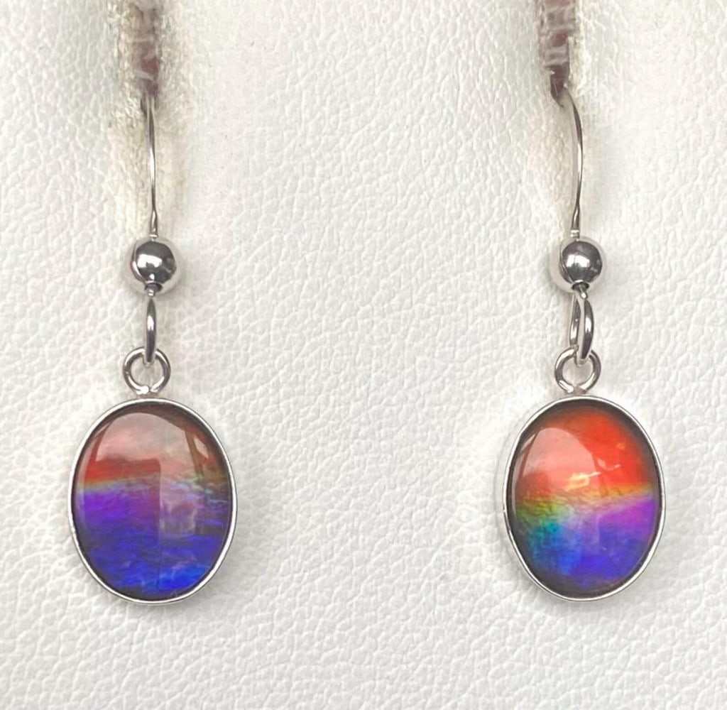 Blue & Pink Oval Cut Ammolite Earrings: Blue &; Pink Oval Cut Ammolite Earrings These Ammolite earrings feature subtle hints of pink, though the tones are muted, and the gems are slightly dark. The 10mm x 8mm low-dome quartz-capped triplets