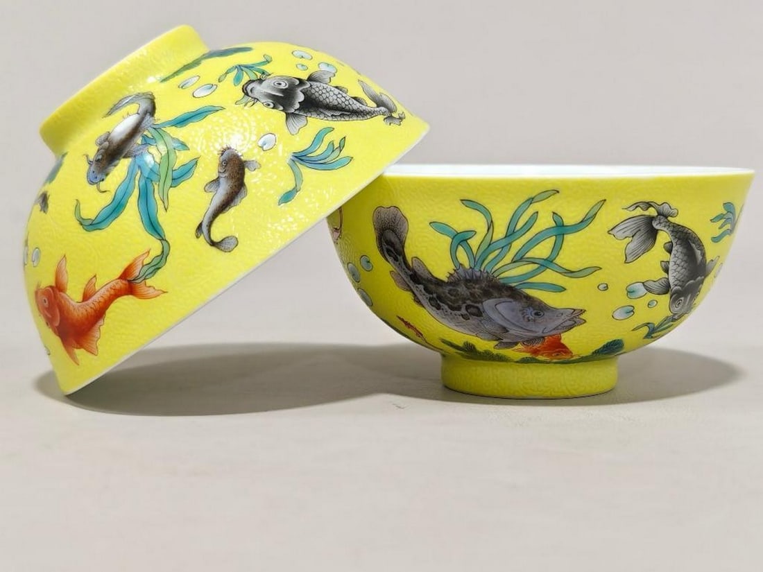 Pair of Qing Yongzheng Mark Enamel Bowls with Auspicious Fish: Pair of Qing Yongzheng Mark Enamel Bowls with Auspicious Fish A subperb pair of porcelain bowls, each finely decorated in rich enamel colors with lively depictions of auspicious fishes swimming among 
