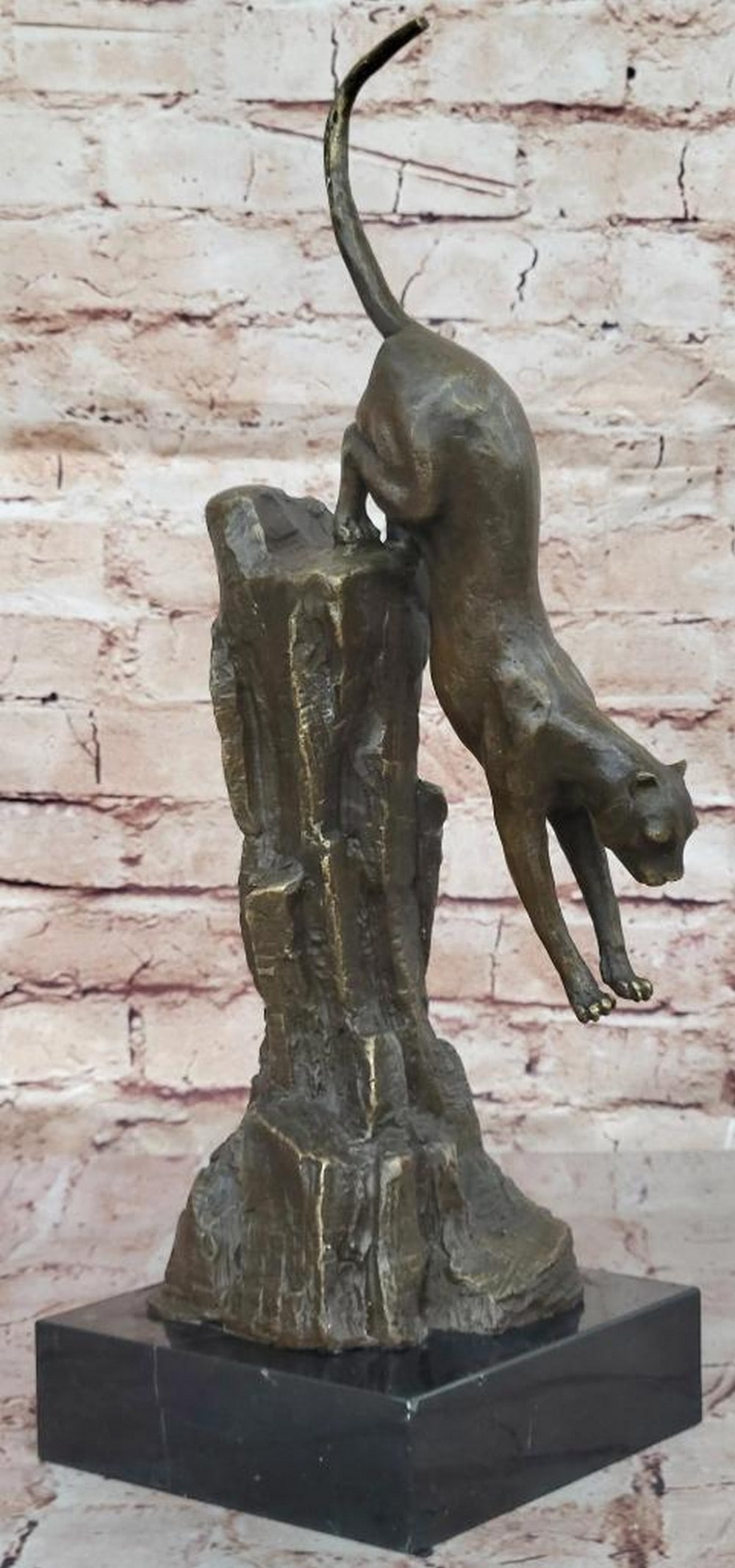 Dynamic ''Cougar Descending Rock'' Bronze Sculpture by Milo - 16'' x 11'': Dynamic "Cougar Descending Rock" Bronze Sculpture by Milo - 16" x 11" The "Cougar Descending Rock" bronze sculpture by Milo captures the power and grace of a mountain lion in m
