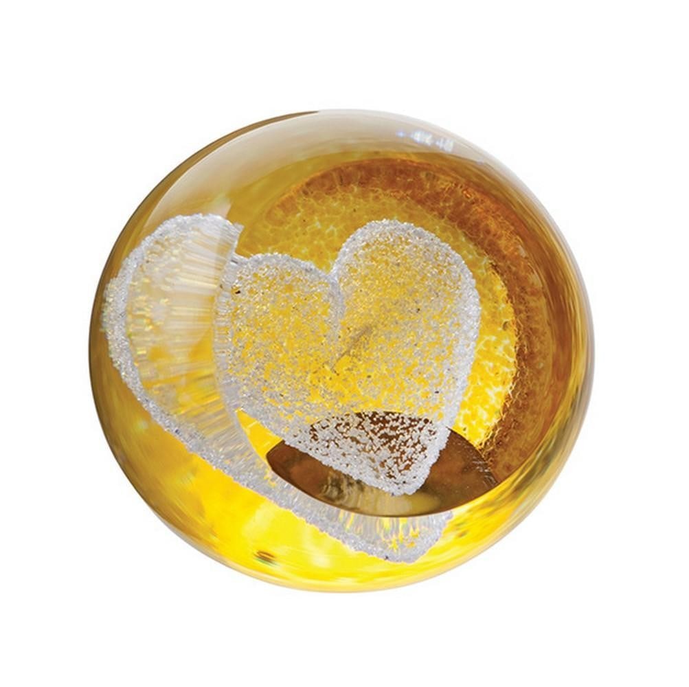 Golden Heart Mini Paperweight: Golden Heart Mini Paperweight A small glass paperweight featuring a delicate heart set against a shimmering golden background. Simple yet charming, it serves as a decorative accent or a thoughtful kee