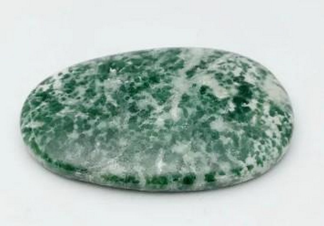 Gentle Calm Green Dot Jade Worry Stone: Gentle Calm Green Dot Jade Worry Stone Worry stones are smooth stones with an indent that are said to ease stress and worry. Common to Buddhist meditation, it is said that a monk would start