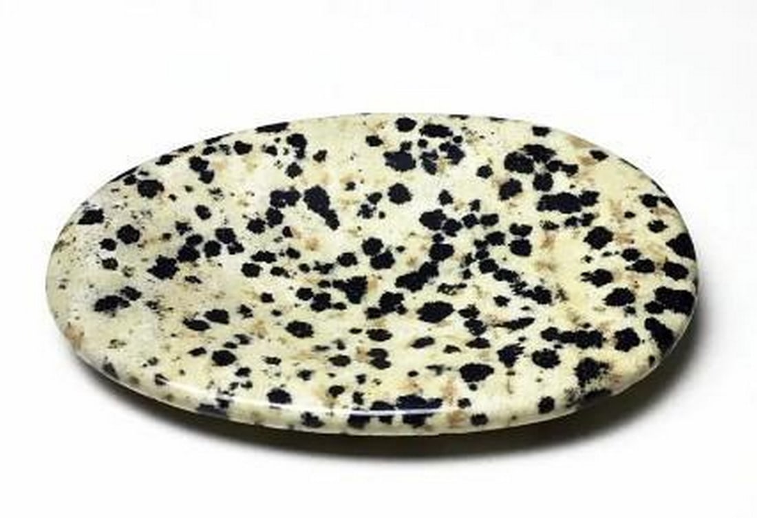 Dalmatian Jasper Worry Stone: Dalmatian Jasper Worry Stone Worry stones are smooth stones with an indent that are said to ease stress and worry. Common to Buddhist meditation, it is said that a monk would start meditating with a