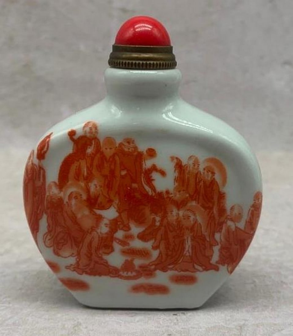 Porcelain Snuff Bottle with Orange Motif & Red Lid: Porcelain Snuff Bottle with Orange Motif &; Red Lid This elegant white porcelain snuff bottle features a finely detailed orange motif depicting a group of men in mid-conversation, evoking scenes of