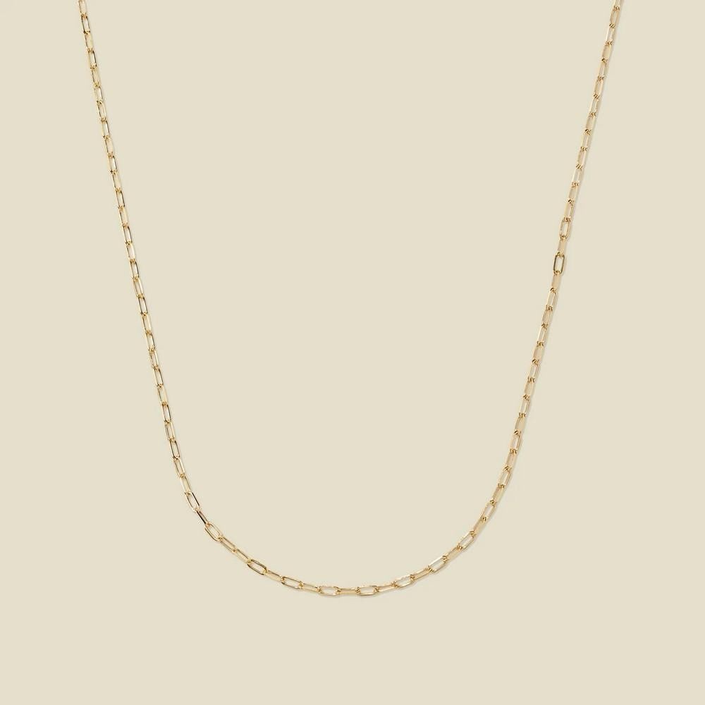 14k Mini Paperclip Chain: 14k Mini Paperclip Chain Craft your perfect look with this refined 14k solid gold chain. Featuring delicate paperclip-style links, it adds a touch of understated elegance and modern sophistication. A