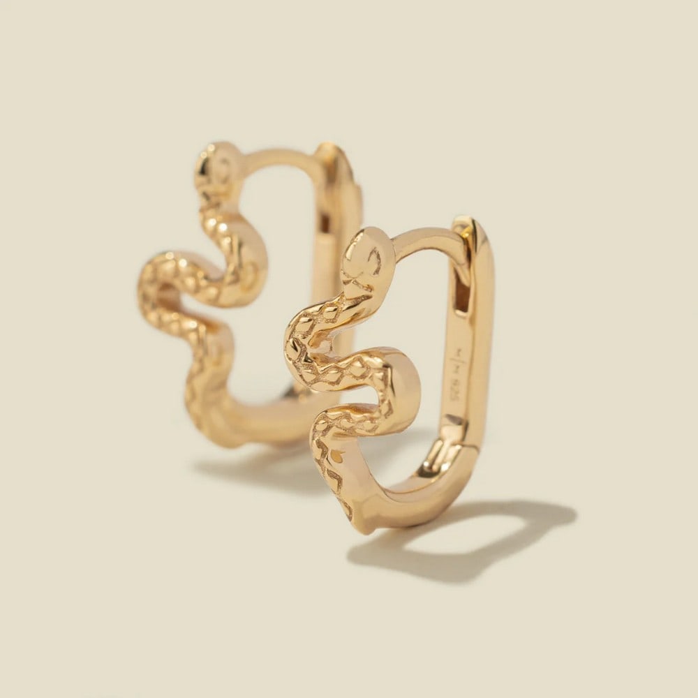 Vermeil Gold Snake Hoop Earrings: Vermeil Gold Snake Hoop Earrings Embrace your inner intuition and the beauty of nature with the Snake Hoop Earrings. These endless hoops feature a hinge-style closure and a lightweight design, offerin
