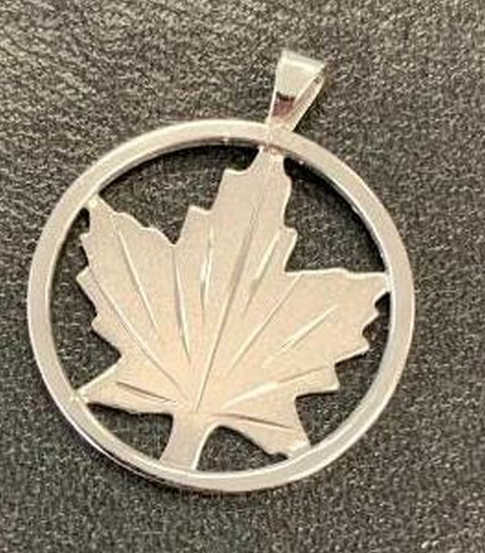 Sterling Silver Maple Leaf Pendant: Sterling Silver Maple Leaf Pendant Celebrate natural beauty with this elegant sterling silver pendant featuring a finely detailed maple leaf encircled by a sleek, polished ring. Symbolic and