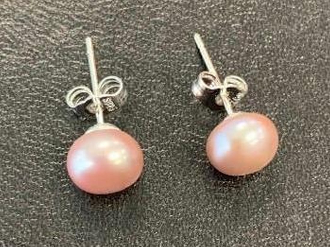 Pearl Stud Earrings in Sterling Silver: Pearl Stud Earrings in Sterling Silver Elevate any outfit with the timeless beauty of these white pearl stud earrings, set in sterling silver. Each pair features luminous white pearls. The minimalist