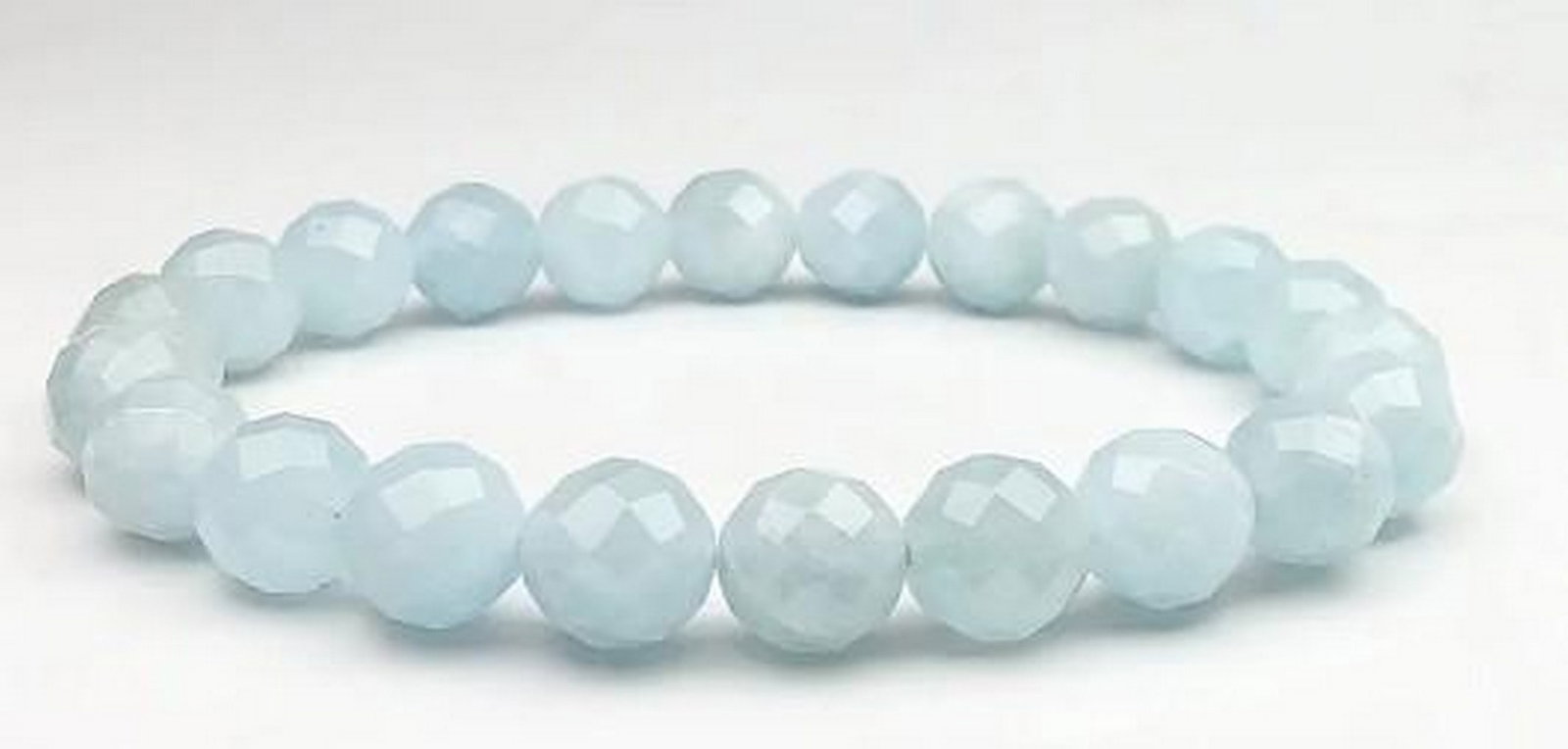Blue Tranquility Aquamarine Bracelet: Blue Tranquility Aquamarine Bracelet Inspired by the tranquil waters of the ocean, this aquamarine faceted beaded bracelet features shimmering beads that catch the light with every movement. Known