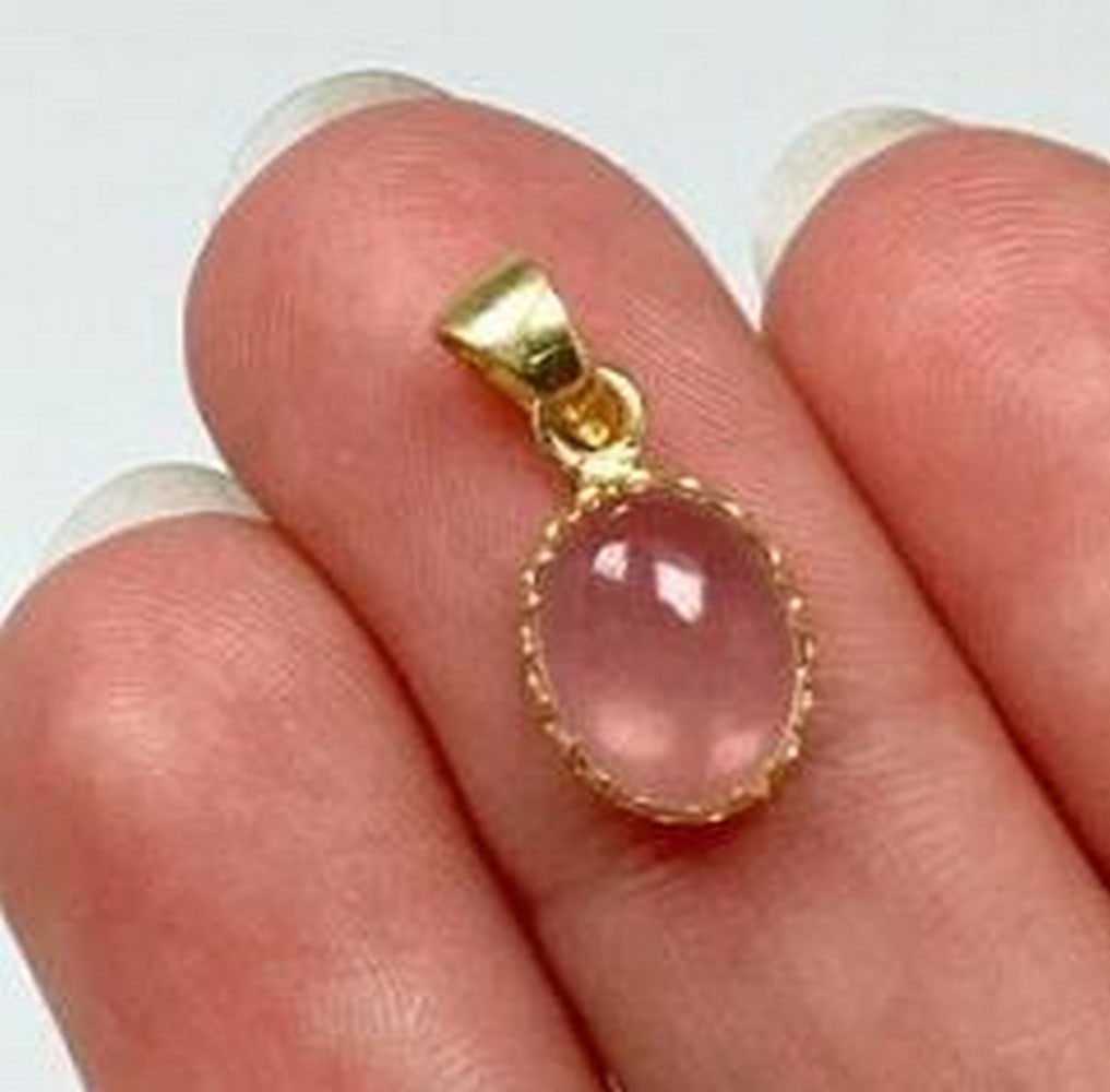 Rose Quartz Sterling Silver With Gold Finish Pendant: Rose Quartz Sterling Silver With Gold Finish Pendant. Soft elegance meets timeless beauty in this pendant. Featuring a delicately polished Rose Quartz gemstone, known as the Stone of Love, this pendan