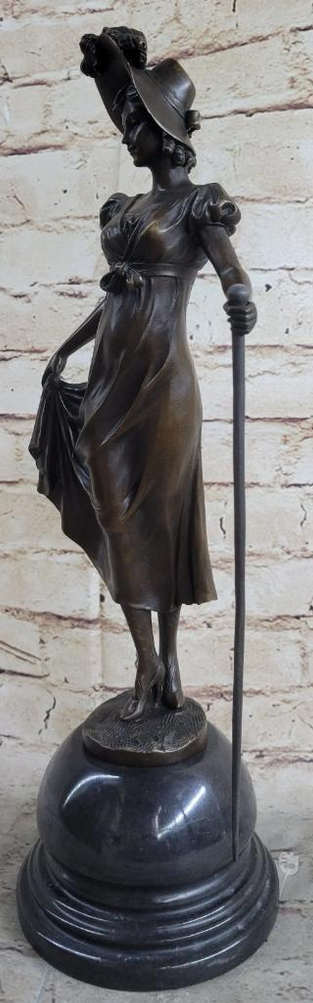 Strolling Elegance Bronze Sculpture Inspired by Preiss - 16'' x 7'': Strolling Elegance Bronze Sculpture Inspired by Preiss - 16" x 7" This captivating bronze sculpture depicts a graceful young woman strolling through the countryside, evoking both charm and all