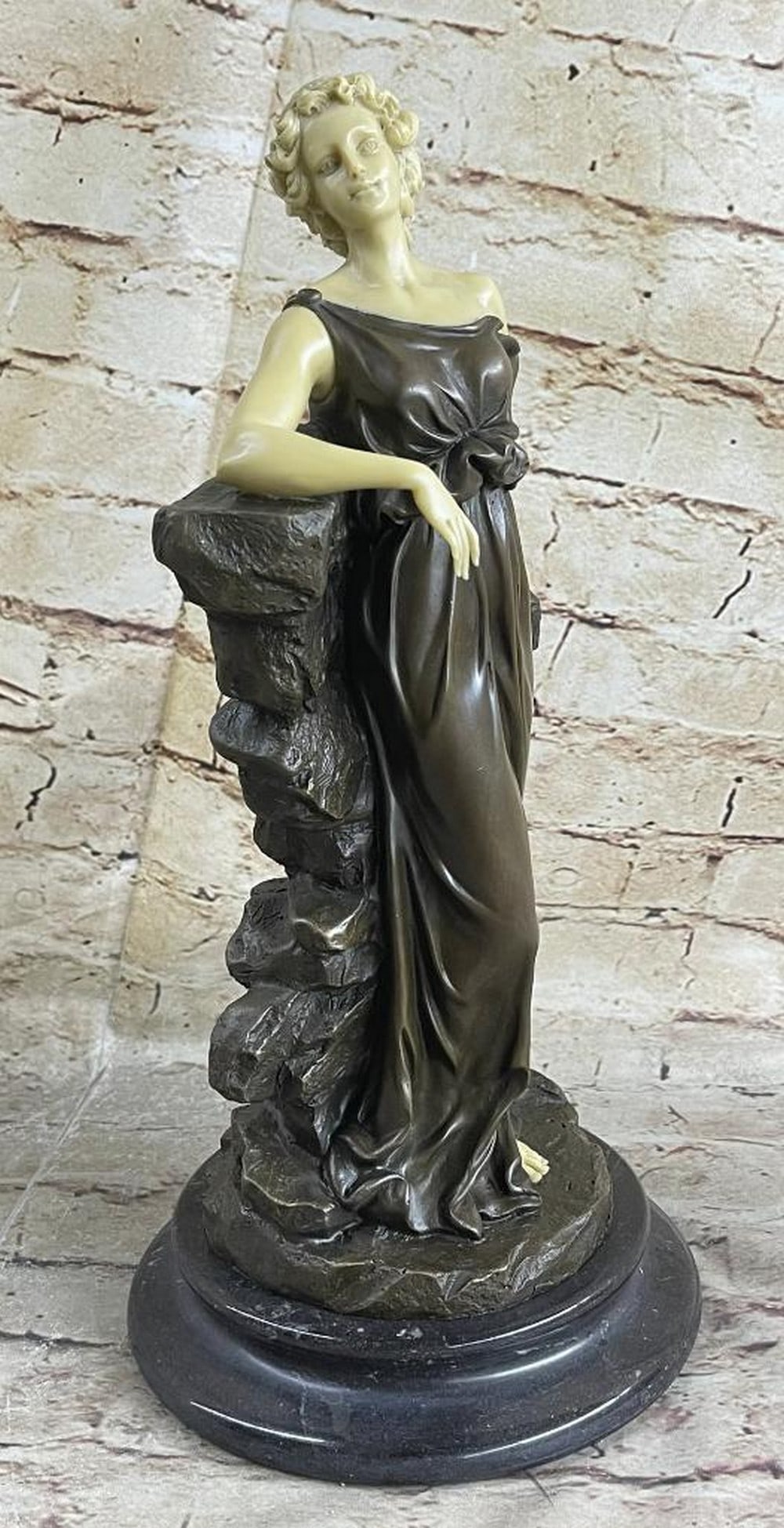 Victorian Women Leaning on Rock Pillar Inspired Bronze Statue - 13'' x 6'': Victorian Women Leaning on Rock Pillar Inspired Bronze Statue - 13" x 6" This striking sculpture depicts a captivating woman gracefully standing beside a unique tree. Dressed in a stunning gow