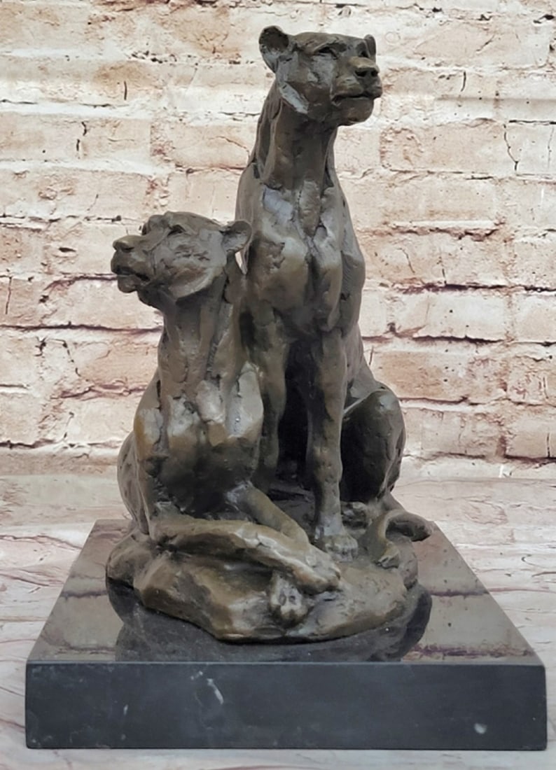 Pair of Female Lionesses Bronze Sculpture with Marble Base - 11'' x 12'': Pair of Female Lionesses Bronze Sculpture with Marble Base - 11" x 12" Crafted with meticulous care and artistic vision, this sculpture brings to life the powerful presence of two mountain lio