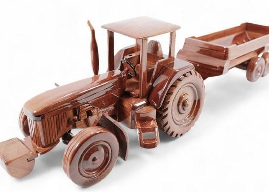 Tractor: Tractor The Tractor is beautifully recreated in this handcrafted scale model. Made of solid mahogany and finely detailed, this model has a clear polyurethane high gloss finish has deep wood grain and
