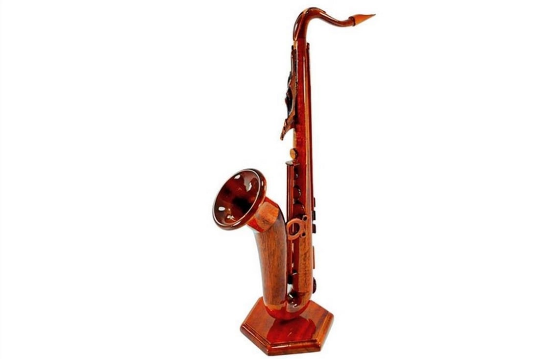 Mahogany Saxophone Figurine: Mahogany Saxophone Figurine This handcrafted saxophone figurine is carved from solid mahogany with remarkable detail. The polished wood grain highlights its elegant curves, capturing the charm of the
