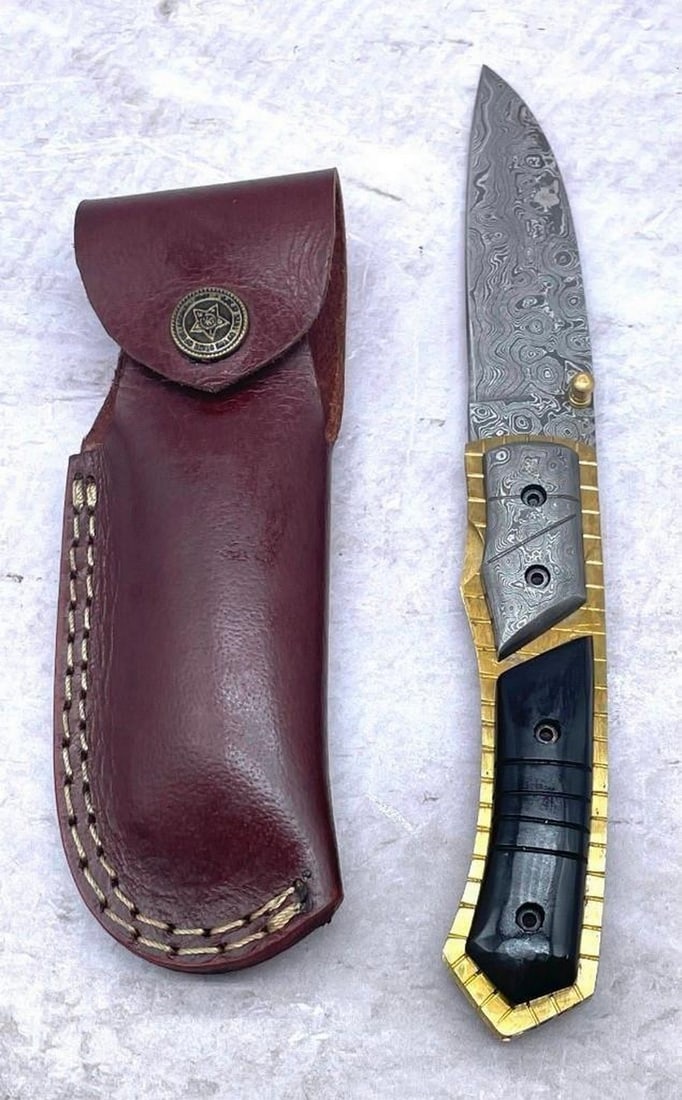 Blood Borns Folding Damascus Knife: Blood Borns Folding Damascus Knife. Each blade is created Using 256 Layers Of 1095 and 15N20 High Carbon Steels?????? To Produce A Superior Edge And Maintain A High Tensile Strength In the Steel. The