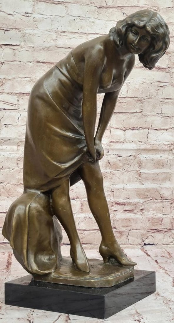 Art Nouveau Original Bronze Sculpture of a Woman by Jean Patoue - 20.5'' x 8.5'': Art Nouveau Original Bronze Sculpture of a Woman by Jean Patoue - 20.5" x 8.5" This elegant Art Nouveau bronze sculpture by Jean Patoue captures a woman in a graceful moment, delicately adjustin