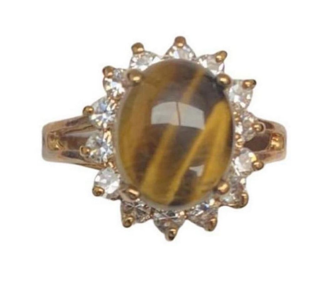 Tiger Eye Gemstone Ring Encased in Triangular Austrian Crystals With 18KTGP Band: Tiger Eye Gemstone Ring Encased in Triangular Austrian Crystals With 18KTGP Band This stunning piece captures the essence of a sunflower s radiance with a central Tiger s Eye gemstone that exudes warm