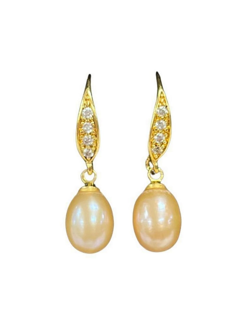 Pink Pearl Crystal Drop Earrings: Pink Pearl Crystal Drop Earrings These earrings feature lustrous pink pearls that dangle gracefully from the golden setting. The golden elements add a touch of warmth and luxury to the design. Adornin