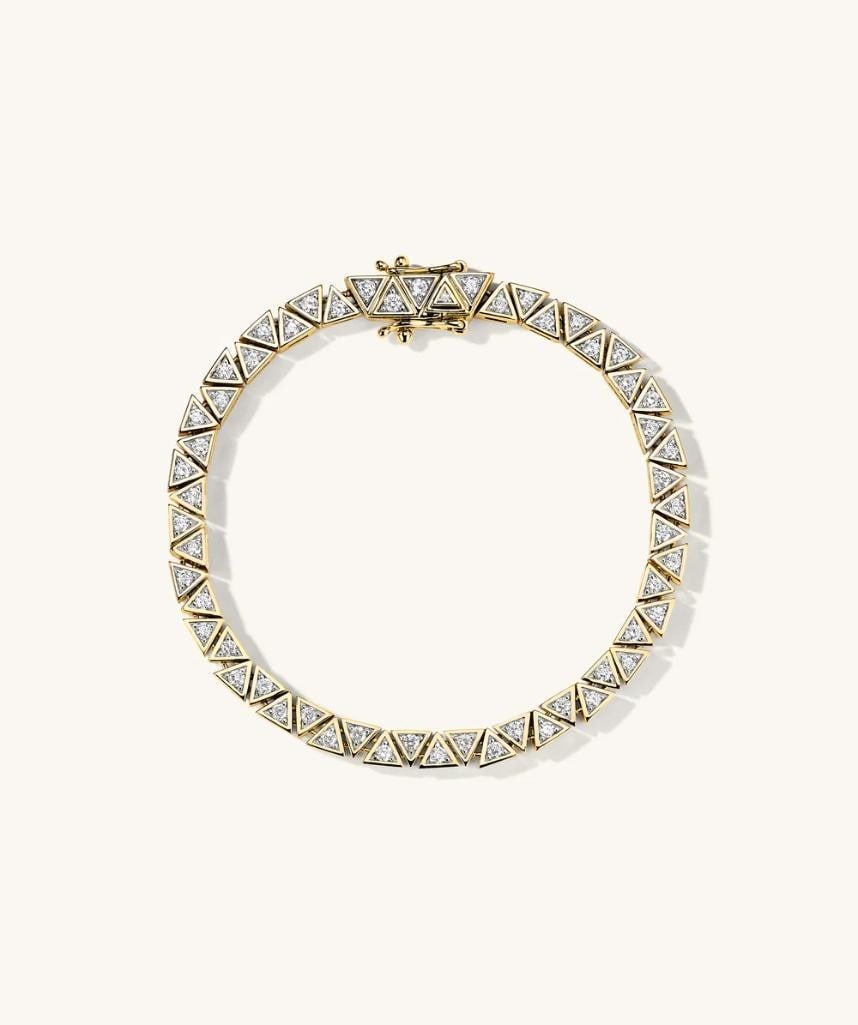 14k Yellow Gold Patra Diamond Tennis Bracelet: 14k Yellow Gold Patra Diamond Tennis Bracelet In a league of its own. Make a bold statement with pieces handcrafted in 14k gold and adorned with responsibly sourced diamonds. Details: - Average Carat