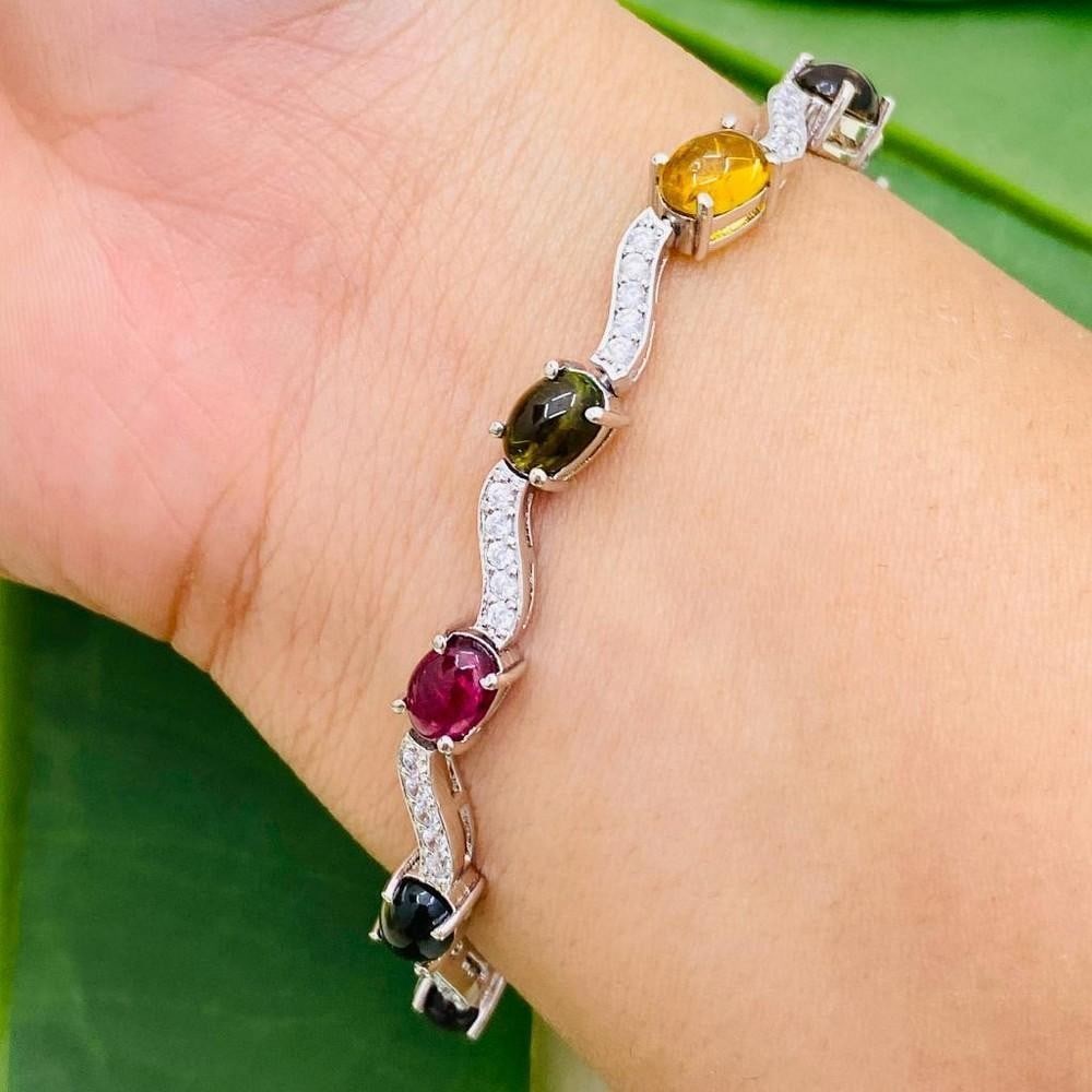 Tourmaline and Zirconia Studded Bracelet: Tourmaline and Zirconia Studded Bracelet This stunning 925 Sterling Silver bracelet is studded with gorgeous tourmaline of yellow, pinkish red, and brownish green separated by zirconias, making it