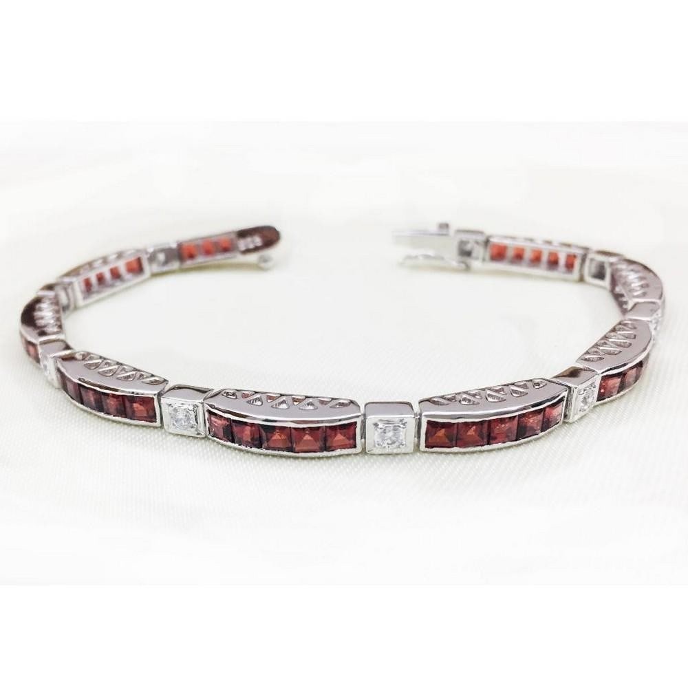 Garnet Blocks Studded 925 Sterling Silver Bracelet: Garnet Blocks Studded 925 Sterling Silver Bracelet This bracelet is 925 Sterling Silver and features square faceted garnet stones with sqaures of zirconia in between. Size of Gemstones: 3x3mm View