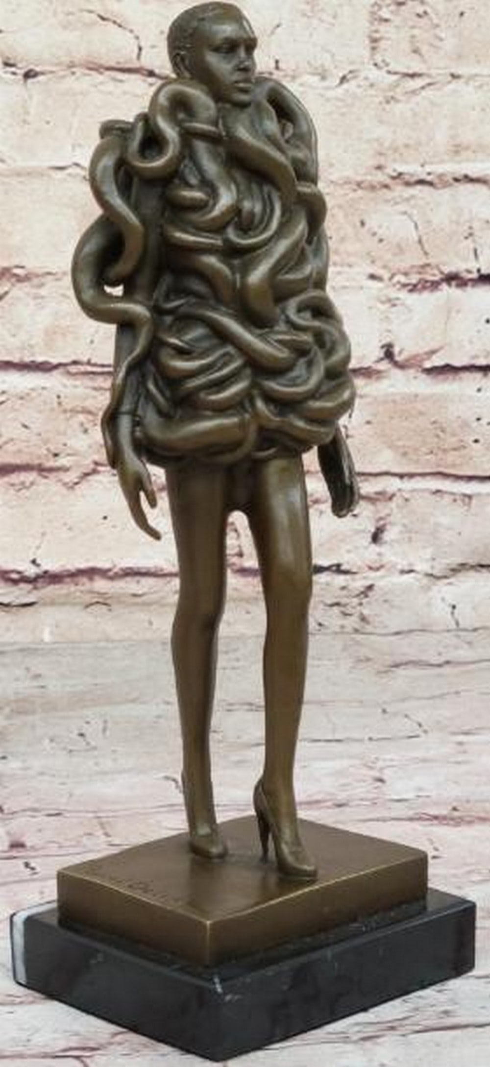 Venom & Vogue Bronze Sculpture: Venom & Vogue Bronze Sculpture This bold and seductive bronze sculpture, bearing the signature of artist Pascal Delor, presents a striking vision of feminine power and allure. The woman strides forwar