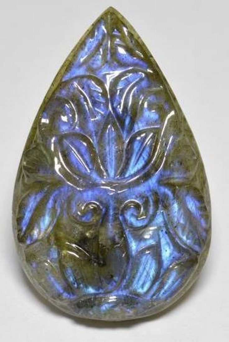22.73 ct Carved Pear Earth Tones Labradorite Gemstone: 22.73 ct Carved Pear Earth Tones Labradorite Gemstone Unveiling our Carved Pear Earth Tones Labradorite Gemstone-a wearable masterpiece that seamlessly combines the artistry of carving with the enchan