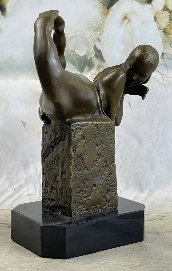 Bronze Mermaid Figure Sculpture – 9" x 7": Bronze Mermaid Figure Sculpture – 9" x 7" This bronze sculpture depicts a mermaid resting on a rocky perch with finely detailed scales, flowing hair, and surrounding seashells. A crown of fl