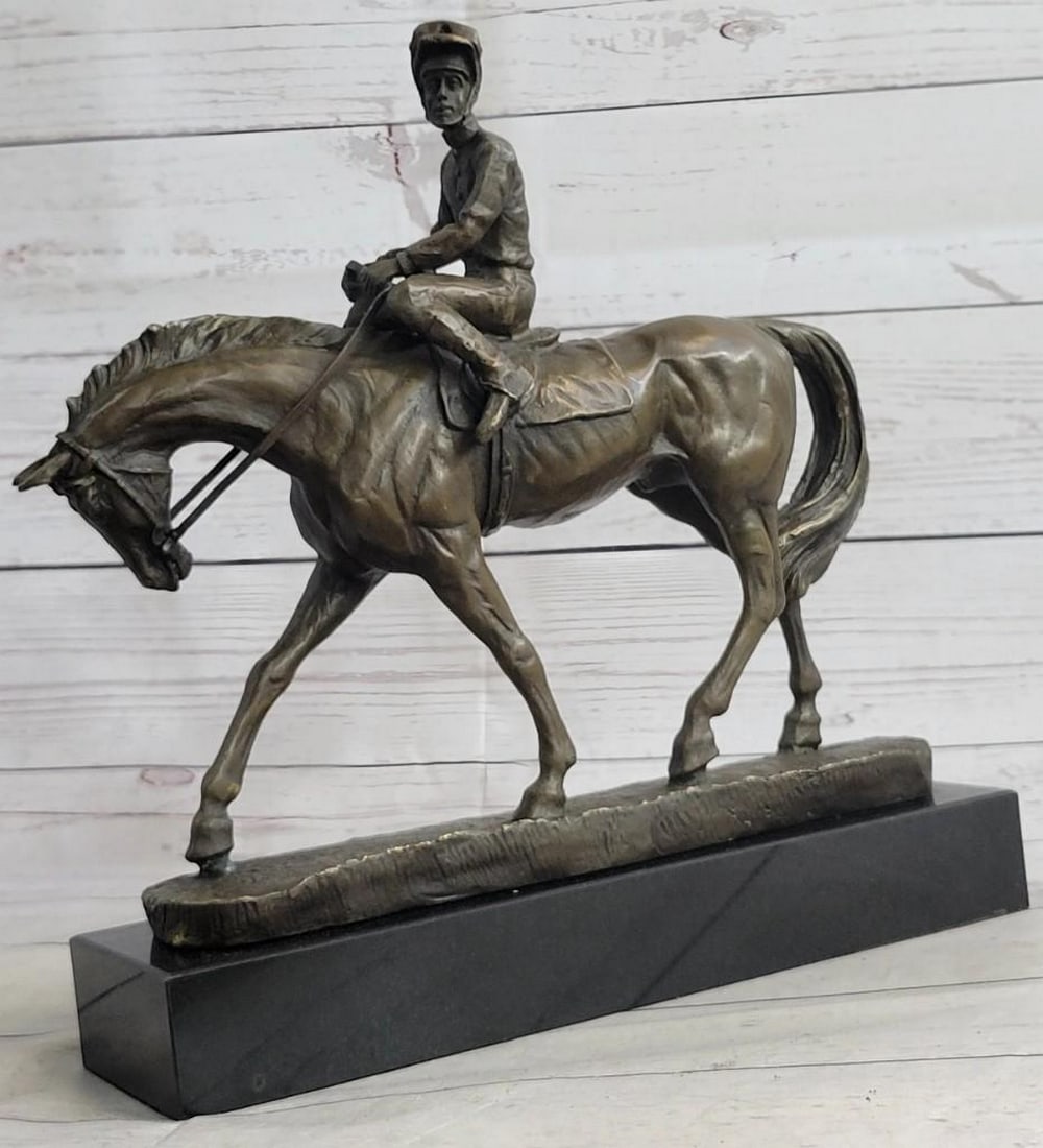 The Polo Champion Bronze Sculpture: The Polo Champion Bronze Sculpture This dynamic bronze sculpture bearing the signature of artist Aldo Vitaleh captures the exhilarating motion of a polo jockey in full stride. The horse, muscles taut 