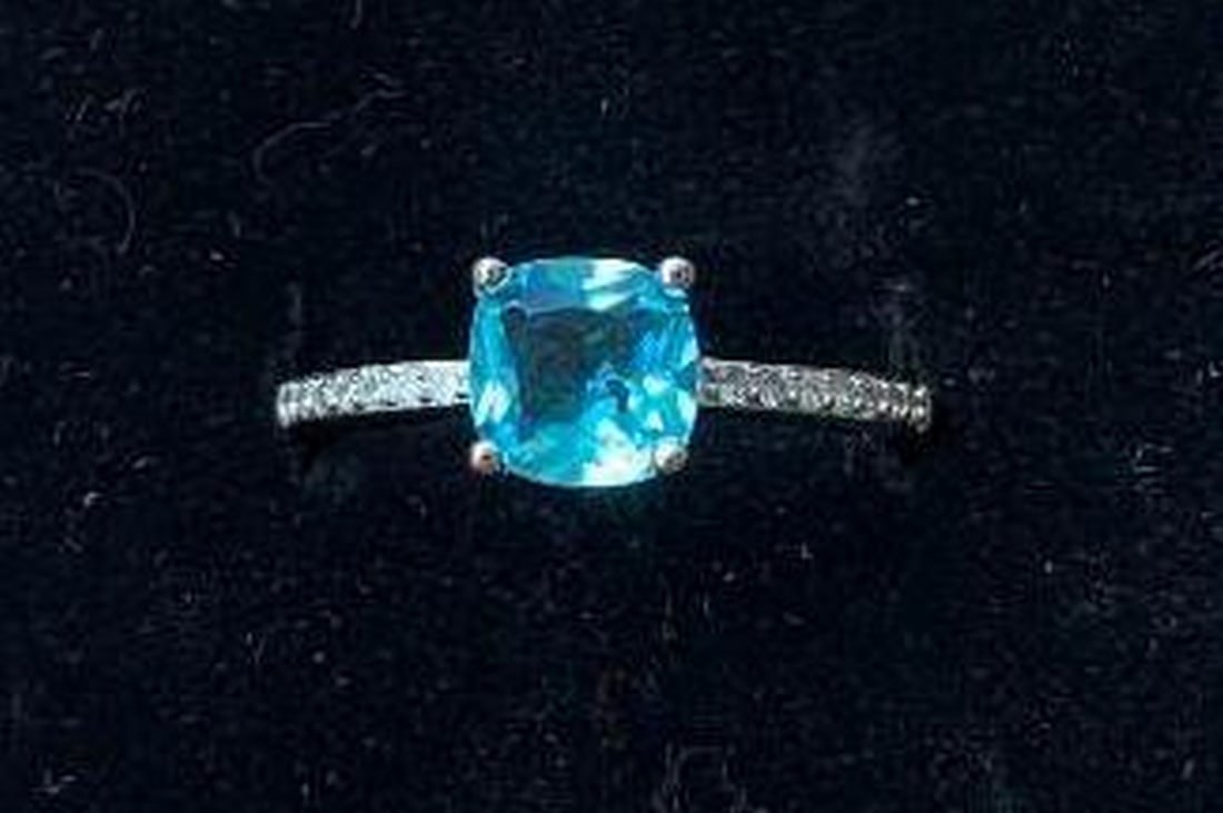 Sterling Silver Cushion-Cut Light Blue Stone Ring: Sterling Silver Cushion-Cut Light Blue Stone Ring Crafted in sterling silver, this exquisite ring showcases a cushion-cut light blue stone, radiating a serene and soothing aura. The stone is beautiful