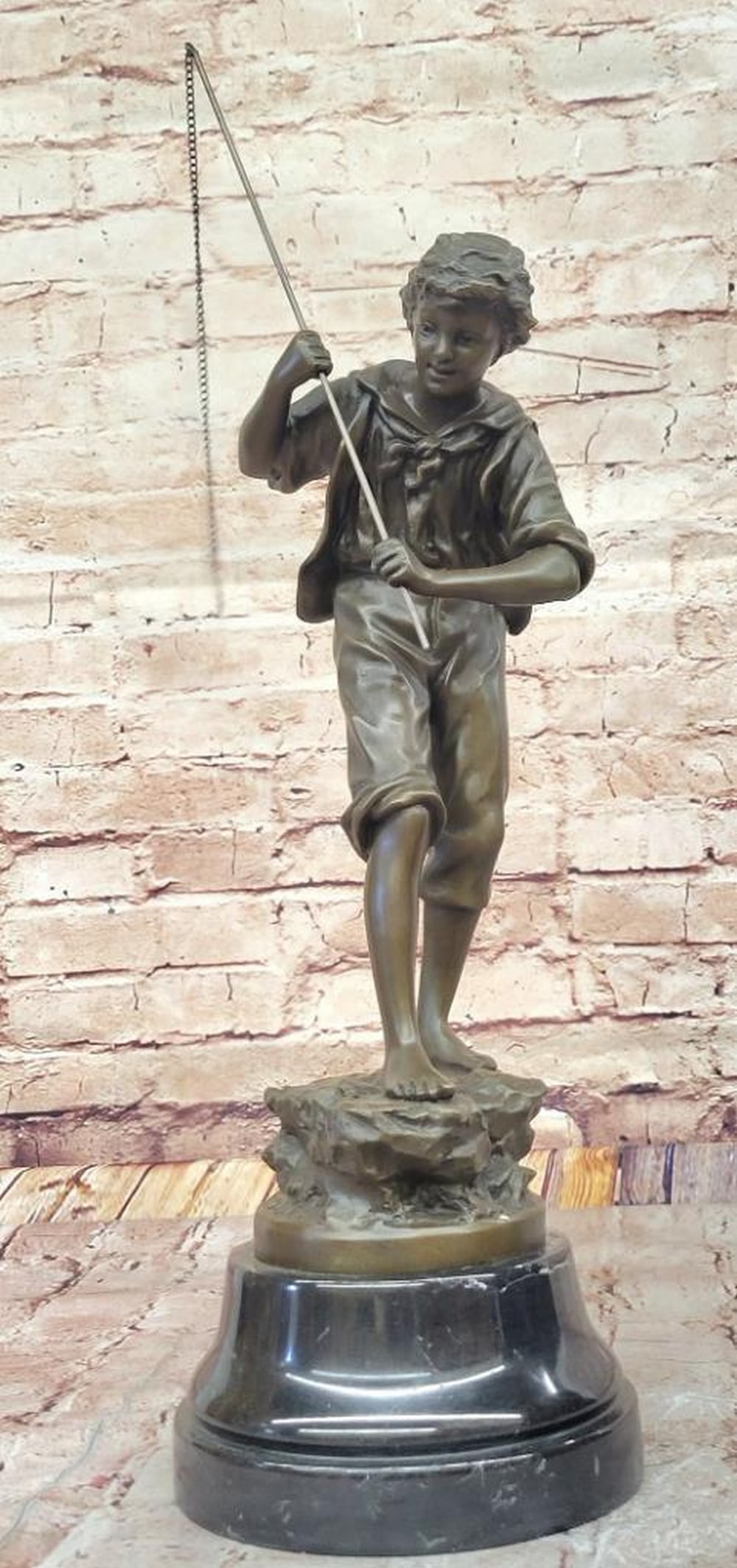 The Young Fisherman" Bronze Sculpture Inspired by Rancoulet - 20.5" x 7: "The Young Fisherman" Bronze Sculpture Inspired by Rancoulet - 20.5" x 7" This charming bronze sculpture, "The Young Fisherman," captures the innocence and joy of youth engaged