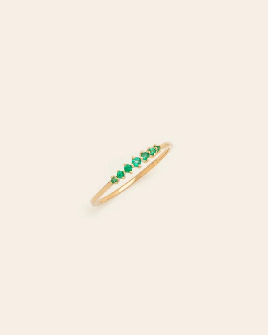 14k Solid Gold Prong Set Emerald Band: 14k Solid Gold Prong Set Emerald Band This 14K solid gold band showcases a row of vibrant emeralds, each securely held in a classic prong setting. The rich green gemstones are beautifully complemented