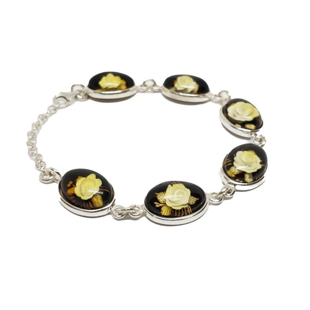 Cognac Amber Rose Cameo Bracelet: Cognac Amber Rose Cameo Bracelet This elegant bracelet features a series of cognac amber cameos, each delicately carved with a detailed rose motif. The amber's warm, honeyed tones beautifully comp