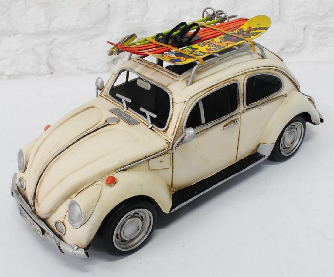 Die Cast 1957 White VW Beetle: Die Cast 1957 White VW Beetle Add sporty style to any space with our Rustic Herbie 1957 VW Beetle Toy Car. Featuring a rustic iron frame and detailed beige metal seat and handlebars, this vintage car 