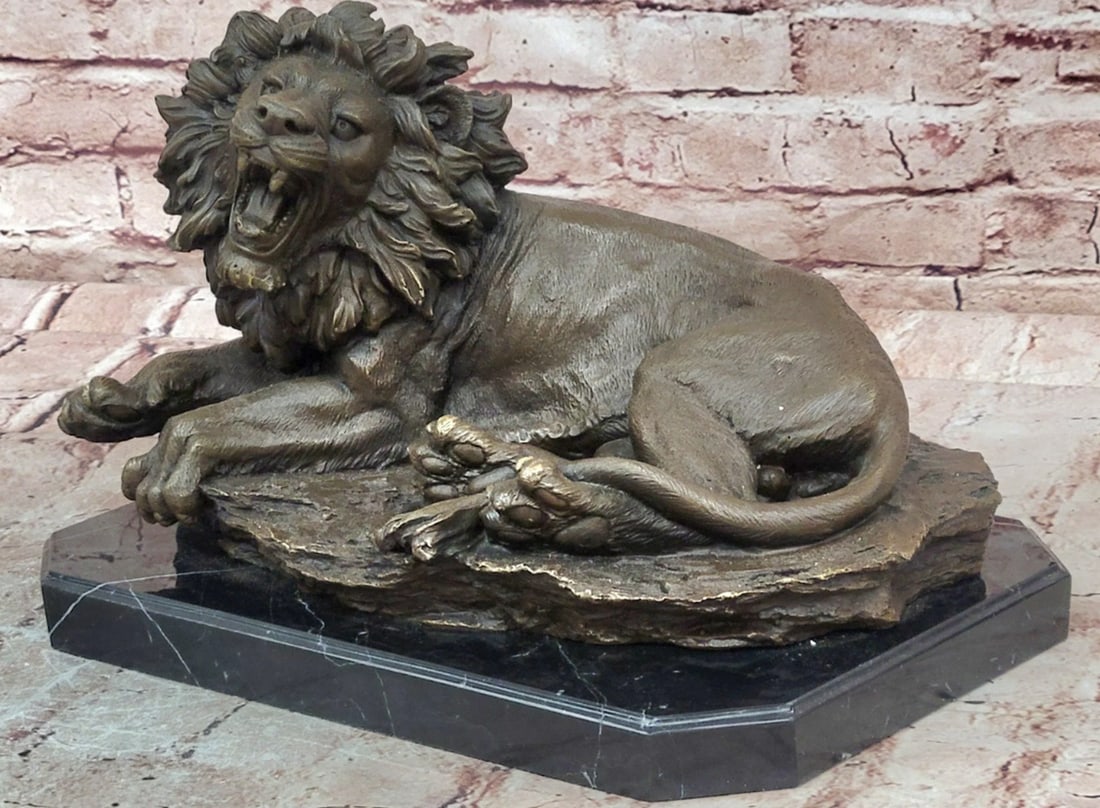 Roaring Lion Bronze Sculpture by Juno - 9.5" x 13.5": Roaring Lion Bronze Sculpture by Juno - 9.5" x 13.5" Introducing a Bronze Sculpture: This depiction of a roaring lion is handcrafted with attention to detail. The figure is shown in a dynamic 