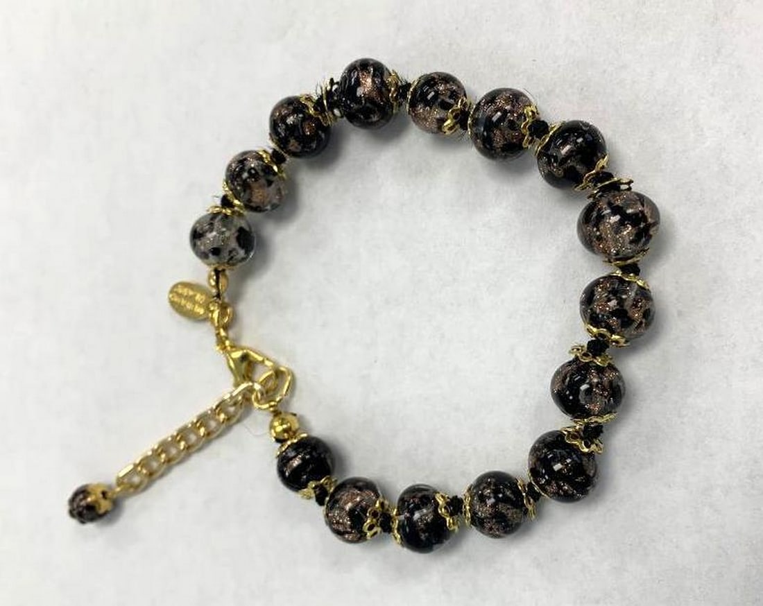 Black & Gold Murano Glass Bead Bracelet: Black & Gold Murano Glass Bead Bracelet This stunning Murano glass bracelet features handcrafted black beads infused with cloudy patches of shimmering gold, creating a mesmerizing, starry-night
