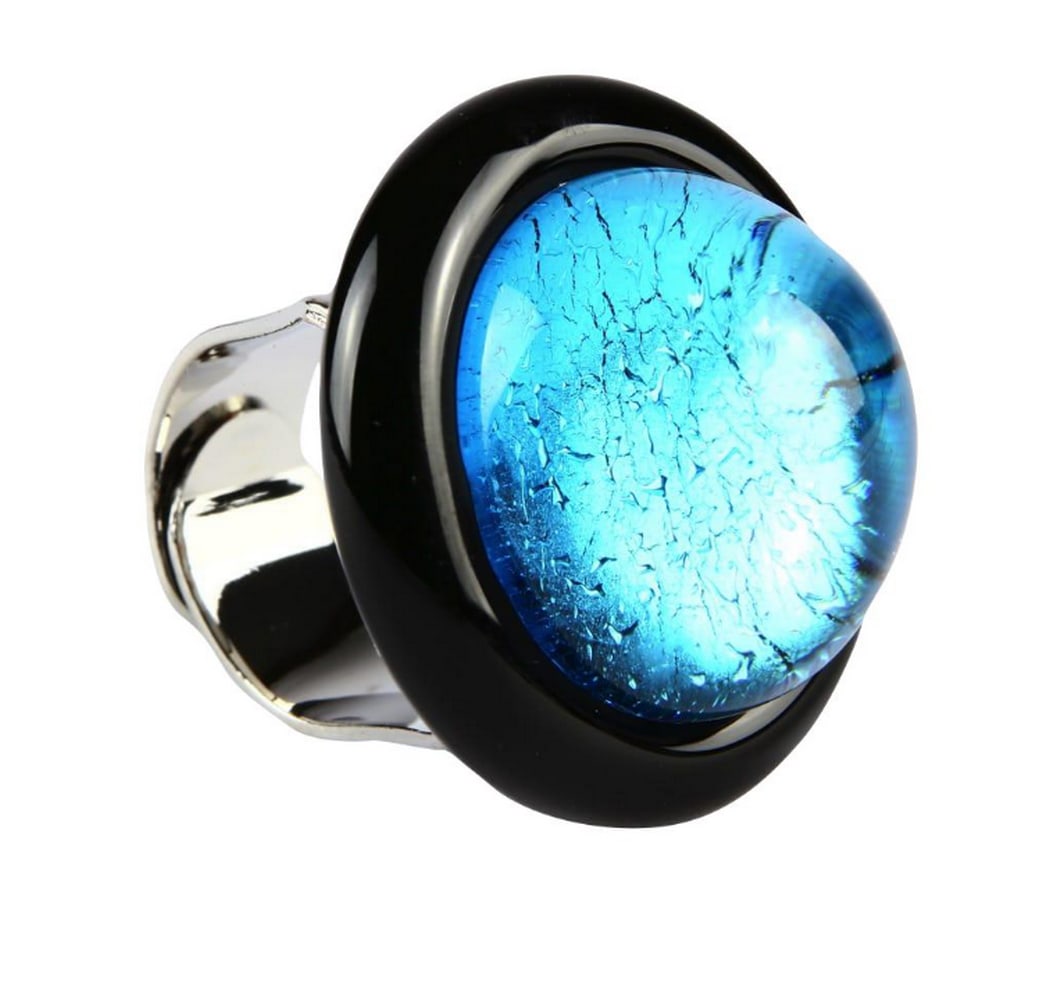 Submerged Light Blue Murano Glass Ring: Submerged Light Blue Murano Glass Ring Glass ring created using submerged hot modeling and embellished with silver leaf decorations. Made from Venetian glass, the ring is adjustable to fit any finger 