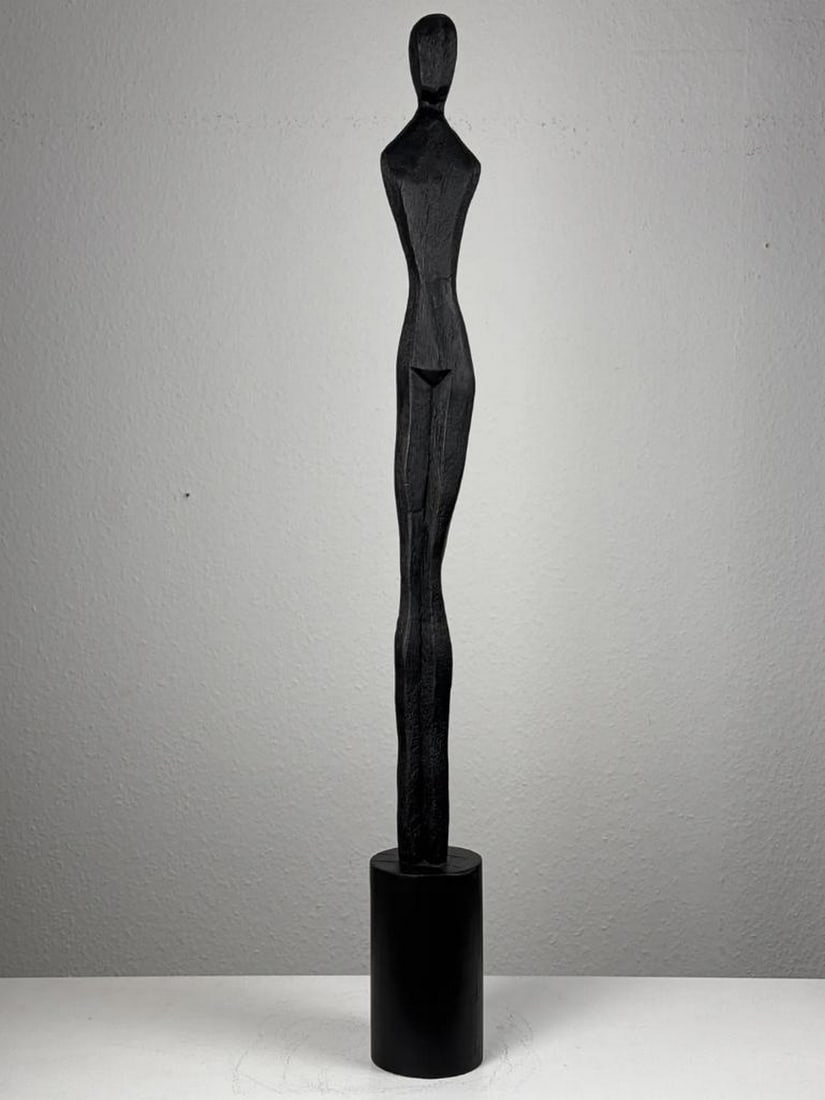 Slim Minimalist Female Sculpture in Black: Slim Minimalist Female Sculpture in Black A sleek and contemporary abstract female figure, crafted with clean lines and finished in a deep black tone. Designed for modern interiors, it makes a strikin