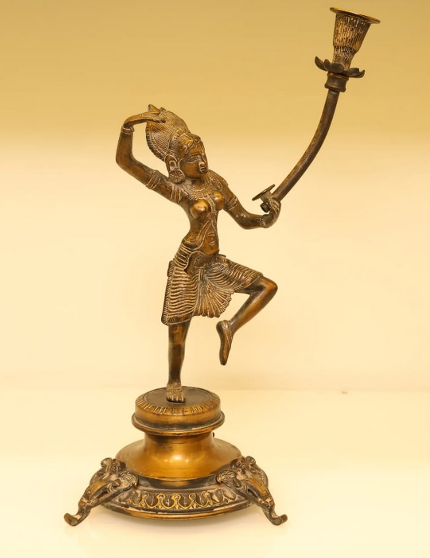 Brass Candle Stand Inspired by Khajuraho – Artistic Candle Holder with Heritage Design: Brass Candle Stand Inspired by Khajuraho – Artistic Candle Holder with Heritage Design Bring a touch of elegance and cultural depth to your space with this Candle Stand – Inspired by Khajuraho Nri