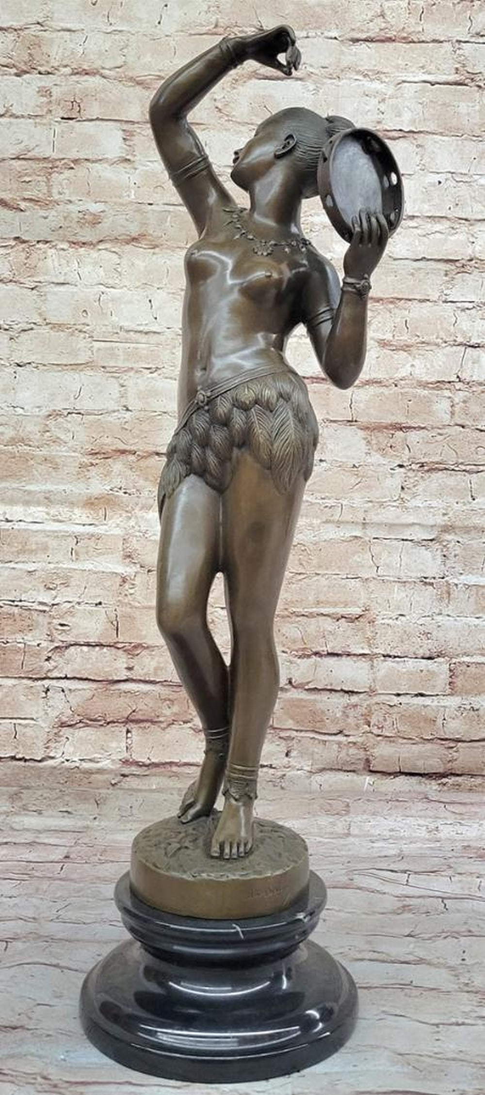 M.C. Bouay's Dancer of Tambourine Inspired Bronze Sculpture on Marble Base - 24.5" x 7": M.C. Bouay's Dancer of Tambourine Inspired Bronze Sculpture on Marble Base - 24.5" x 7" Experience the enchanting allure of M.C. Bouay's Dancer of Tambourine Bronze Sculpture, a mesmer