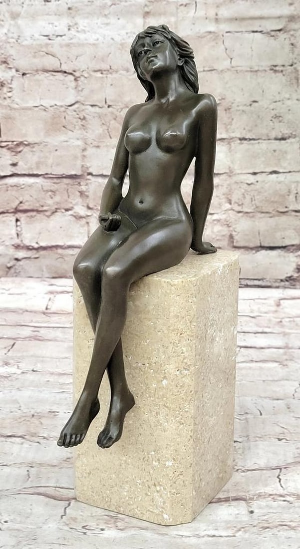 Nude Female Seated on Marble Base Bronze Statue: Nude Female Seated on Marble Base Bronze Statue This captivating bronze sculpture showcases the essence of desire and sensuality with alluring elegance. The seductive pose, crossed legs, and look of e