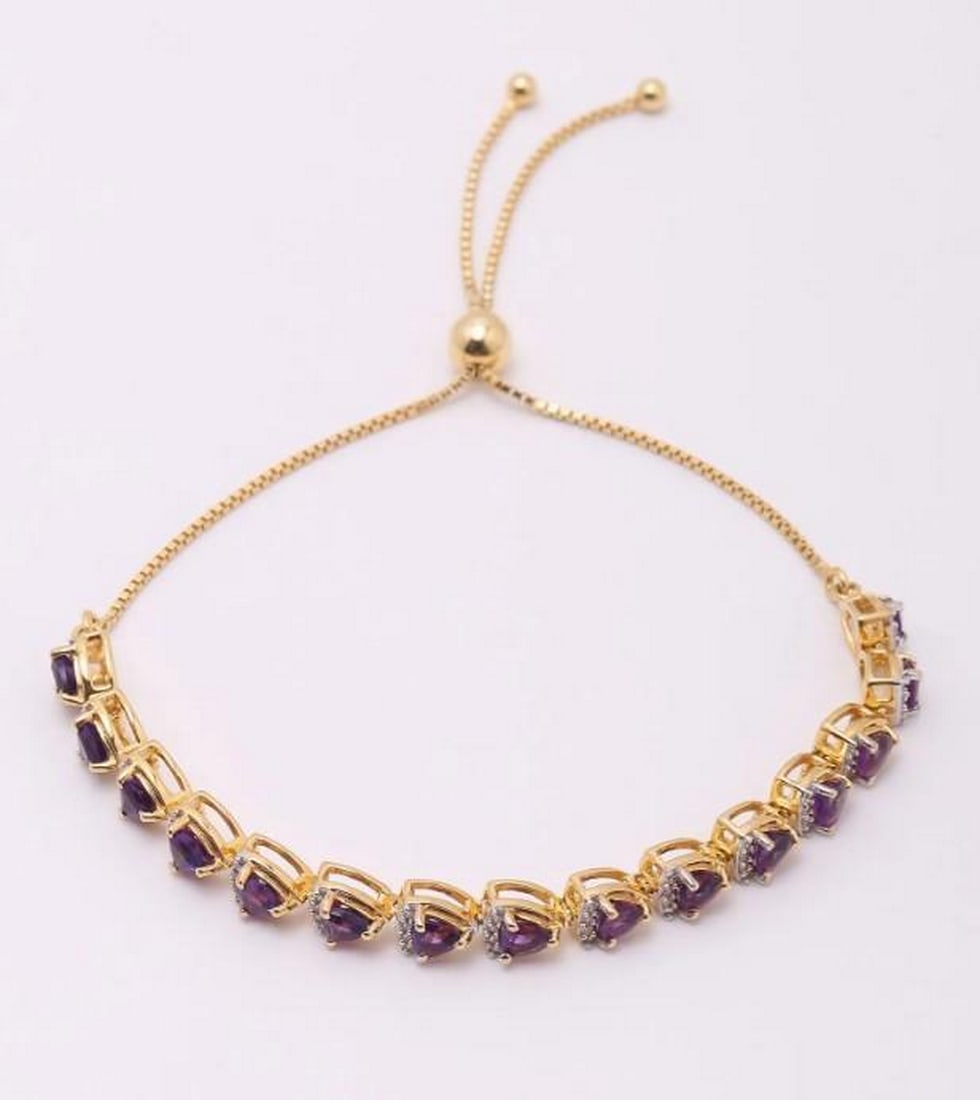 Lavender Summit Wrap Bracelet: Lavender Summit Wrap Bracelet Gracefully encircling the wrist, this wraparound bracelet showcases faceted triangular amethyst gemstones accented with brilliant white topaz. The geometric cuts